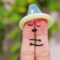 Finger art of a Happy couple. The happy couple kissing and hugging. The concept of safe sex. photo