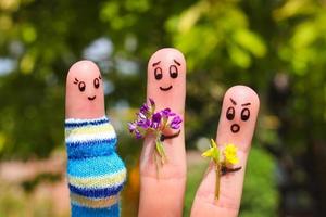 Finger art of Happy couple. Man is giving flowers pregnant woman. Other boy is jealous and angry. photo