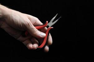 Pliers on dark background photo