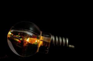 Lightbulb on dark background photo