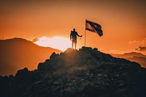 Silhouette of a traveler on mountain peak with flag. The concept of achievement and success. Created with photo