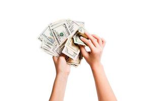 Top view of a bundle of money in female hands. Image of counting dollars on white isolated background. Tax concept photo