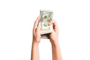 Isolated image of female hands counting dollars on white background. Top view of salary and wages concept photo