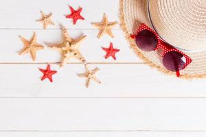 summer holiday beach background with accessories on wooden table, top view with copy space. vacation concept photo