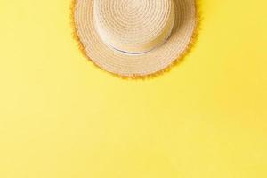 yellow retro straw hat top view with copy space. summer concept on yellow background photo