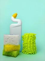 Cleaning agent, sponges and cleaning cloths on a blue background. The concept of cleanliness photo