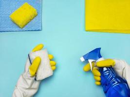 A set of cleaning products for cleaning the house and washing windows. Rubber gloves, sponges, napkins and liquid soap photo