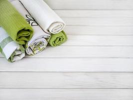 A pile of neatly folded towels on wooden background. Production of natural textile fibers.Organic product. Natural cloth photo