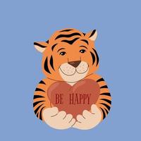 Cute tiger cub with a heart in soft paws on a blue background. Children's illustration of the New Year's symbol of 2022 with a wish of happiness. Vector illustration with the words Be happy.