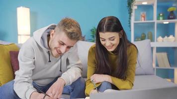 School friends study together at home. Girl and boy gather at home, discuss topics, prepare for university exam or exams, use laptop. video
