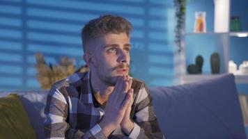 Young man praying, asking god for hope and good day. Young blond blue-eyed man praying, hoping. video