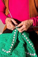 Woman knitting with yarn photo