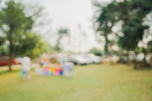 Defocused bokeh and blur background of garden trees in sunlight with vintage toned. photo