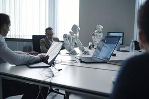 AI robots meeting and working on laptop on table in office photo
