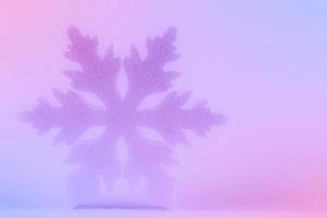 Festive Christmas background. There is a large snowflake on a pink-violet gradient. photo