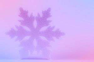 Festive Christmas background. There is a large snowflake on a pink-violet gradient. photo