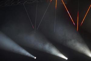 Rays of light from stage spotlights on a dark background. photo