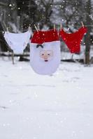 Women's underpants and Santa's Christmas hat are drying on a rope. photo