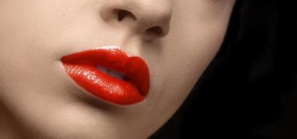 Lips with red lipstick. Red lip makeup detail. Beautiful color lipstick or gloss close-up. photo