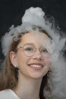 The child is a participant in scientific experiments. Girl in liquid nitrogen smoke. photo