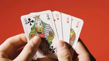 The gambler begins to gamble and throws the playing card on the table. A Poker Player holds the Playing Cards and throws one on the table. video