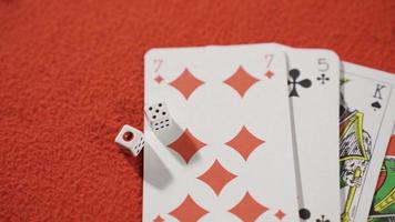 Dice and playing cards on the gambling table. Bet. Playing cards and dice on a red gambling table. video