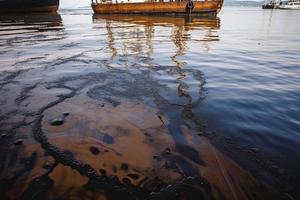 Oil leak from Ship , Oil spill pollution polluted water surface water pollution as a result of human activities photo