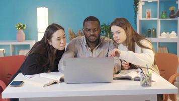 University students of different races home study, brainstorming. Asian, African and European university students study together in harmony at home. video