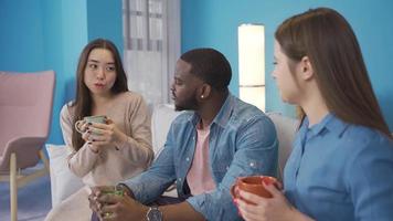 Young people of different races are chatting in a friendly atmosphere. Young people chatting in a friendly atmosphere of different races. African, Asian and European youth. video