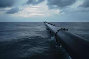 Pipelines disappear in the depths of the ocean. Pipeline transportation is most common way of transporting goods photo