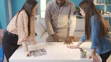 Group of different ethnicities working on architectural project. People of different races working together on architectural project. video