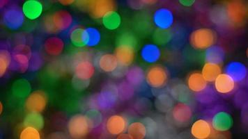 Defocused Xmas lights festive decorations, abstract blurry bokeh background effect. Holiday concept backdrop, twinkling bright shapes. Out of focus glowing celebration texture for use graphic design video