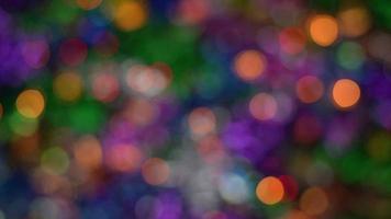 Sparkling lights Happy New Year holiday decorations, abstract blurry bokeh background effect. Defocused glowing colorful lights celebration texture for use at graphic design video