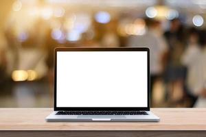 Modern Laptop computer with blank screen on wood table over blur bokeh light background. photo