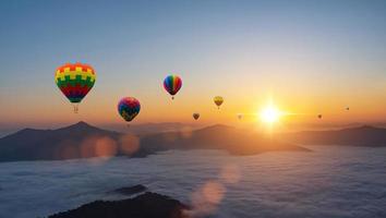 Colorful hot air balloons flying above mountain at sunrise sky background. Travel natural background. photo