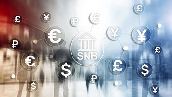 Different currencies on a virtual screen. SNB. Swiss National Bank photo