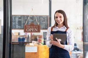 Portrait of a woman, a coffee shop business owner smiling beautifully and opening a coffee shop that is her own business, Small business concept. photo