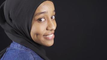 Muslim African young woman in hijab with white shiny teeth. Young beautiful african woman with white and stylish teeth looking at camera and smiling video