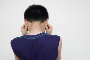 Back view of boy close his ears with two hands. Don't want to listen to anything. Concept, disobey, naughty , negative behaviour. Blame punishment scold. Don't want to listen complain. Bullying. photo