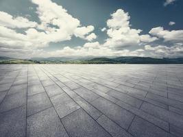 The empty brick square with blue sky and mountain background. photo