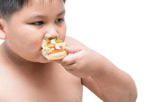 obese fat boy eating seafood pizza photo