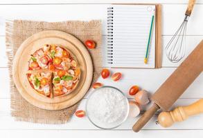 seafood Pizza on top view on white wood background photo