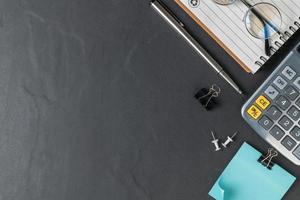 Office black stone desk table with calculator and pen photo