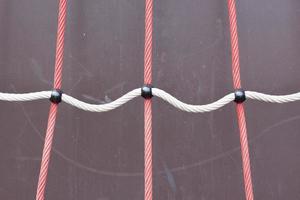 A closeup shot of a rope on a playground with a blurred background. Children's playground rope game photo