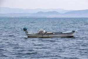 Fishing boat in the Aegean Sea, Turkey. View of the city from the sea. Boat on the sea on a summer day. photo