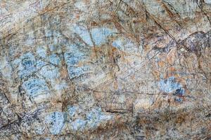 Cracked stone surface brown, grey, blue color. Nature background pattern texture photo