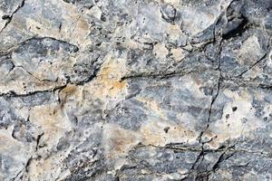 Cracked stone surface grey and brown color. Nature background or pattern texture photo