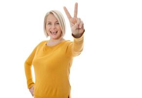 happy excited woman showing the sign of victory photo