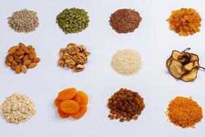 Healthy vegetarian food concept. Assortment of dried fruits, nuts and seeds on white background. Top view. photo