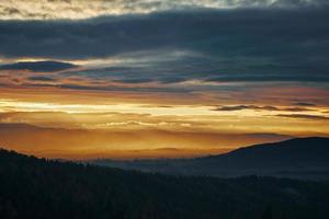 Sunset dramatic sky over mountains shape photo